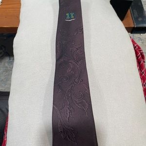 Purple tie with a key coat of arms